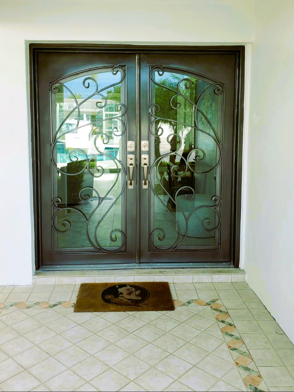 Custom iron entry doors that define the entrance.