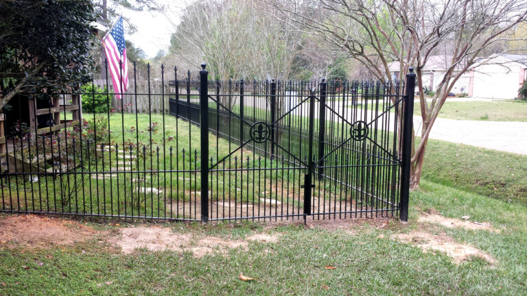 backyard custom wroght iron fence with fleur de lis ornament