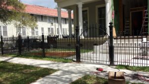 custom wrugh iron fence with pedestrian gate and decorative victorian posts