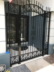custom wrought iron entry gate arched top with spears finials and two fixed panels on the sides