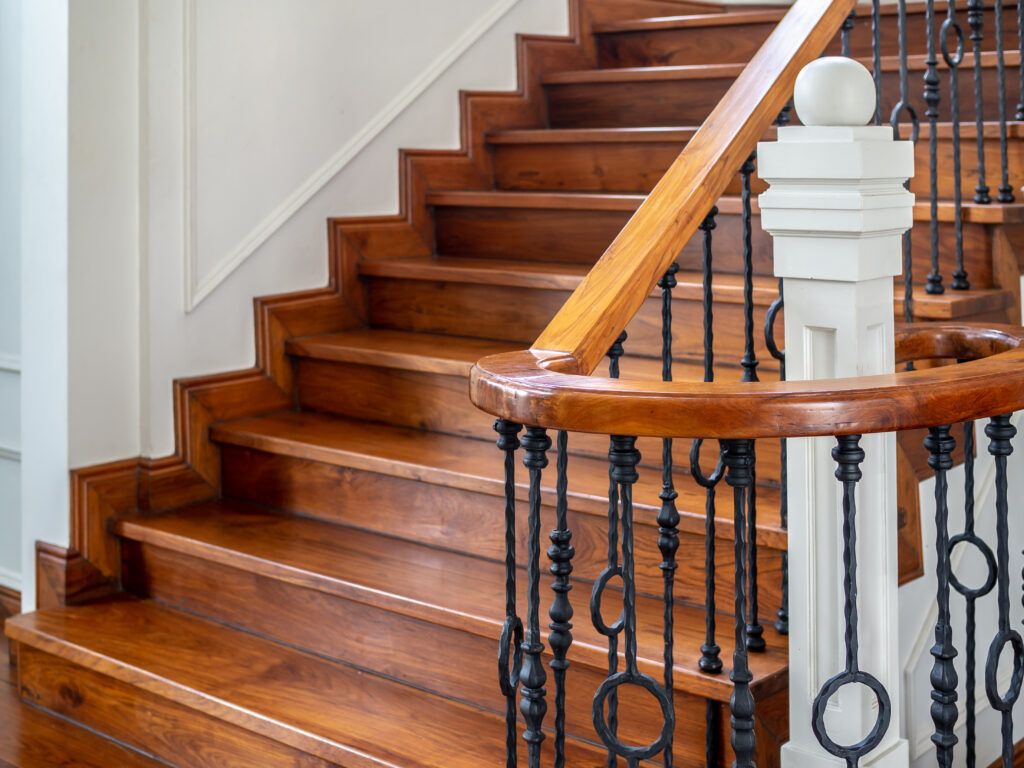 wood stairwell with wrought iron railing and wood handral
