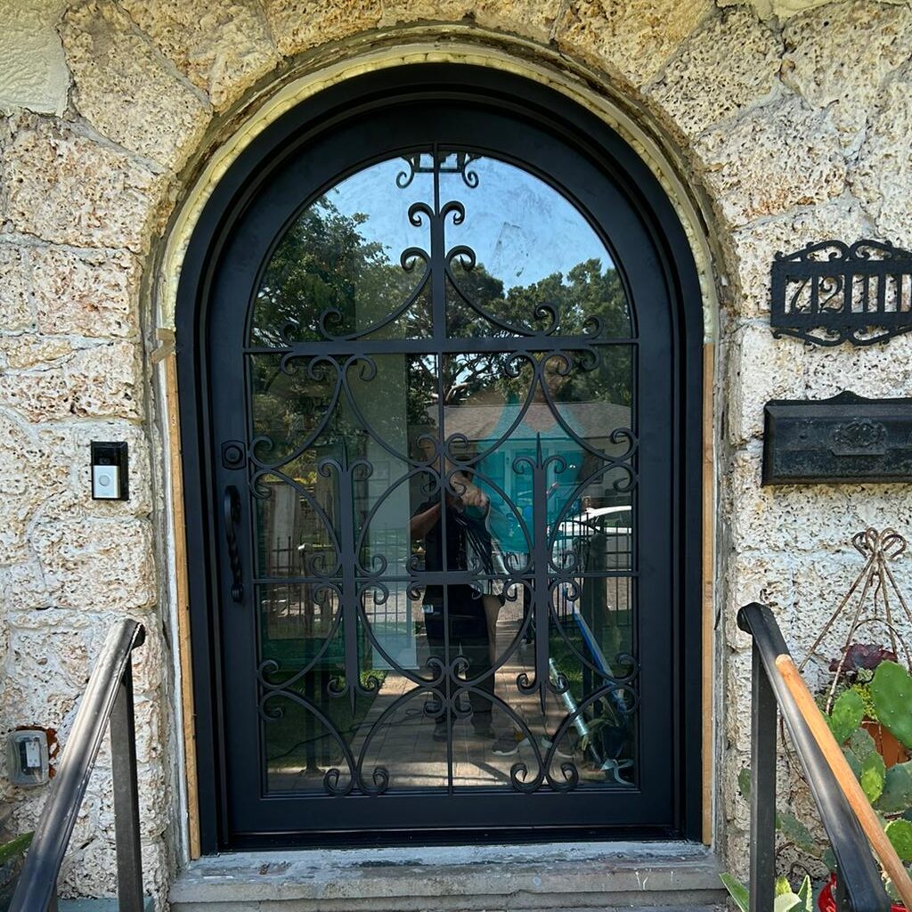 Custom arch top ornamental wrought iron fornt door