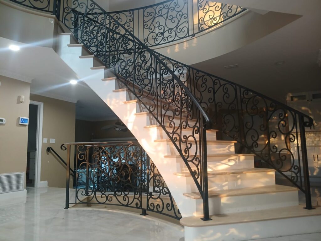 Custom ornamental interior staircase and balcony wrought iron railing