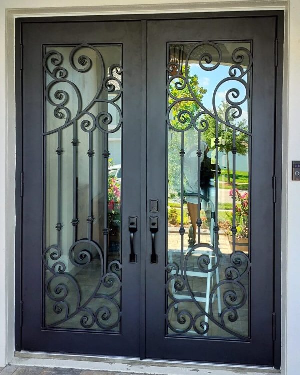 Custom ornamental double swing wrought iron door with impact glass